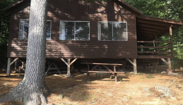 Beachfront Cottage on Ambajejus Lake With Sandy Beach and a Mountain View